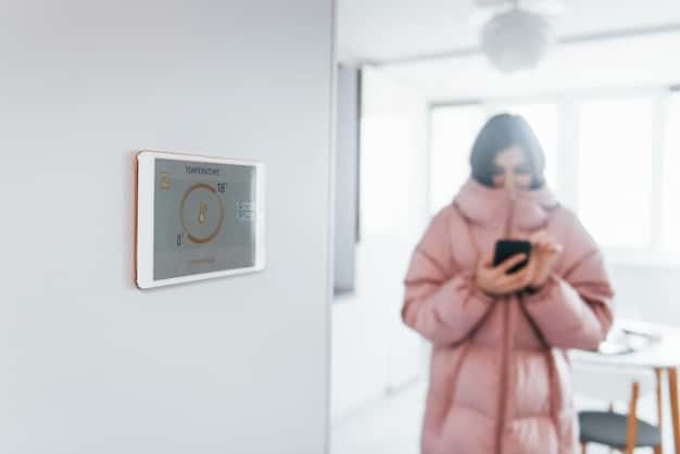 A discreet wall-mounted sensor in a modern living room, subtly integrated into the decor, with an elderly person comfortably reading nearby, symbolizing unobtrusive fall detection technology.