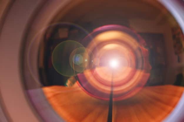 A close-up shot of an 8K projector lens projecting a vibrant, high-resolution image onto a screen, showcasing the sharp focus and detailed light output in a dimly lit room.