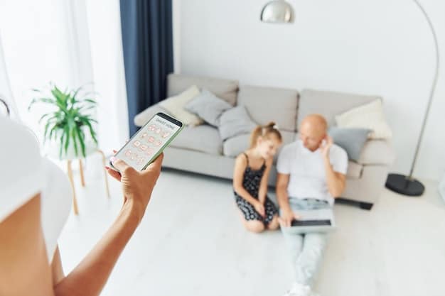 A family looking at a smartphone displaying a smart home app interface showing alerts from various sensors, including a green checkmark for 