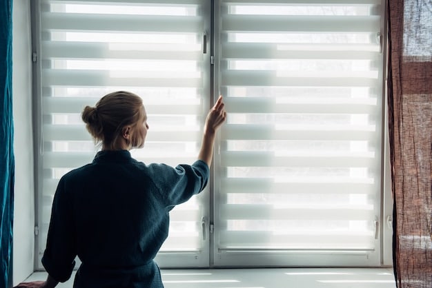 Automated blinds gracefully lowering, indicating smart light control reducing glare on a large living room window.